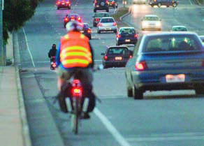 Cyclist riding along a road in the cycle lane