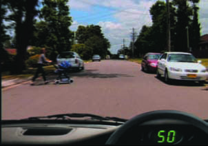 Picture showing a woman with a stroller crossing the road where there is no pedestrian crossing